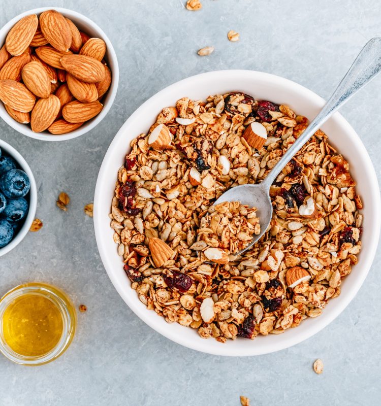 Granola cereals with fresh blueberries, almonds, milk and honey for breakfast.